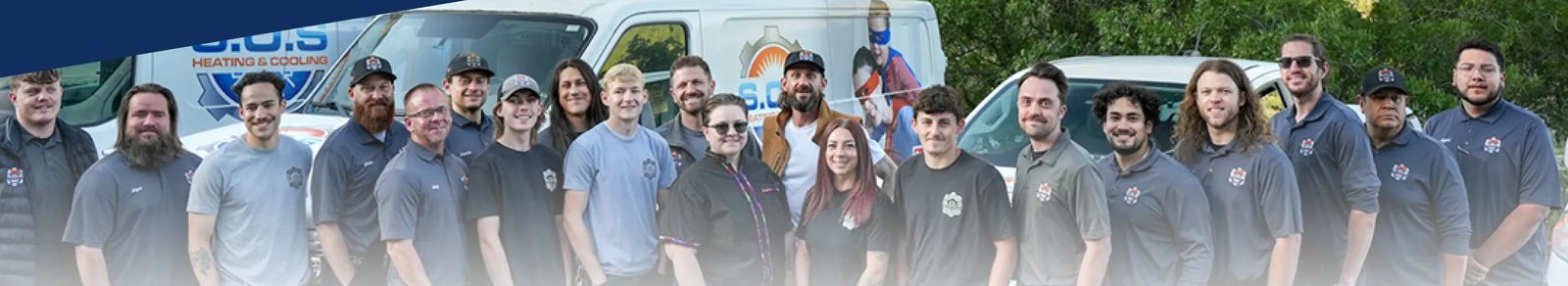 The full S.O.S Plumbing, Heating, & Cooling team in front of their vans